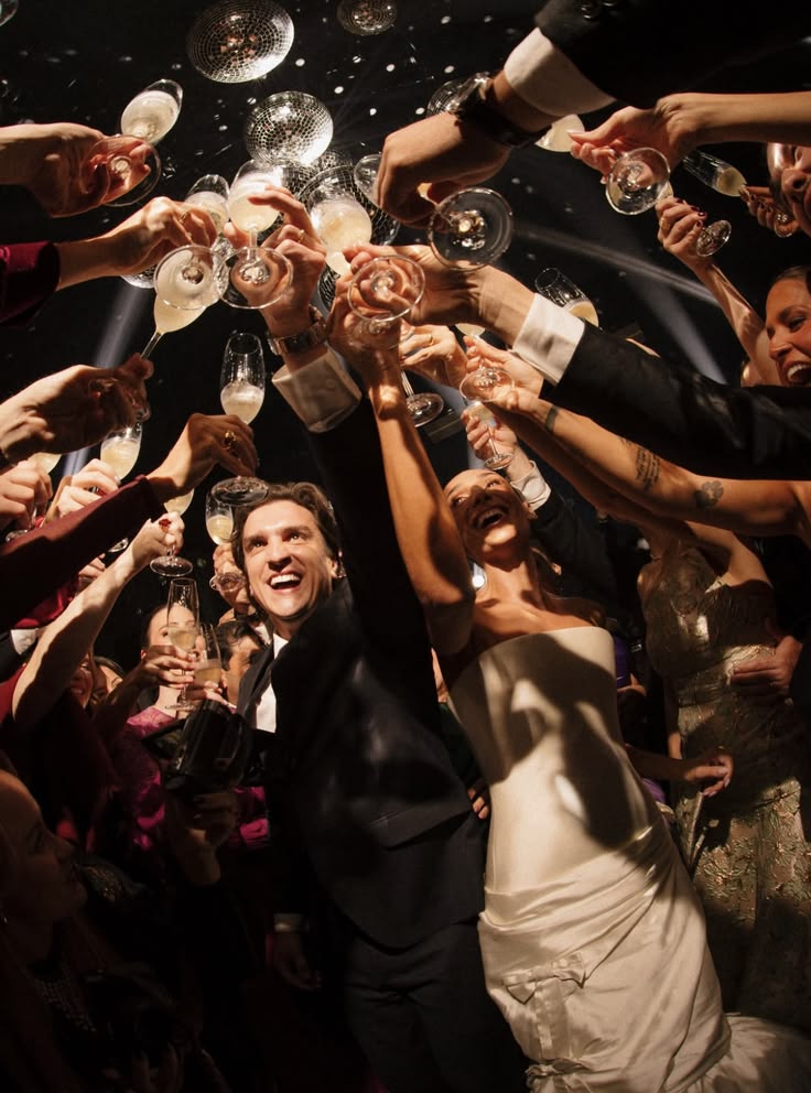 Guests celebrating beneath disco balls
